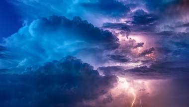 Photo image of storm clouds with streaks of lightning.